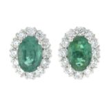 A pair of emerald and brilliant-cut diamond earrings.Total emerald weight 0.98ct.Total diamond