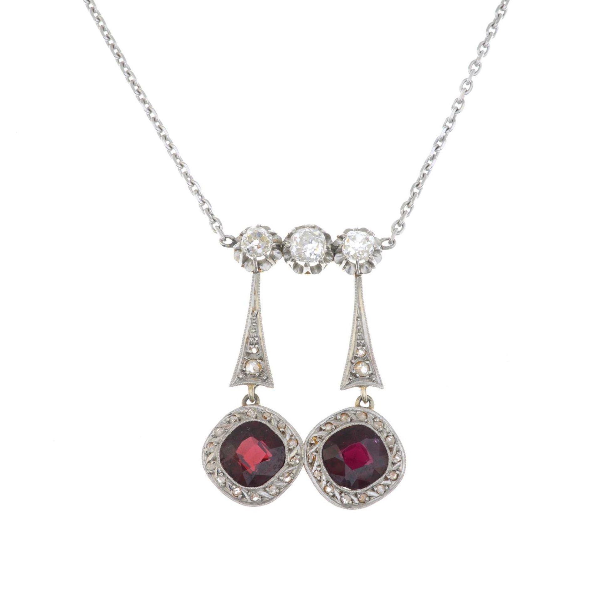 A vari-cut diamond and garnet negligee pendant,