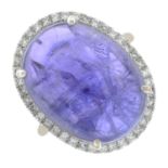 A tanzanite cabochon and diamond cluster ring.