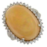 An 18ct gold opal cabochon and brilliant-cut diamond cluster ring.Opal weight 17.88cts,