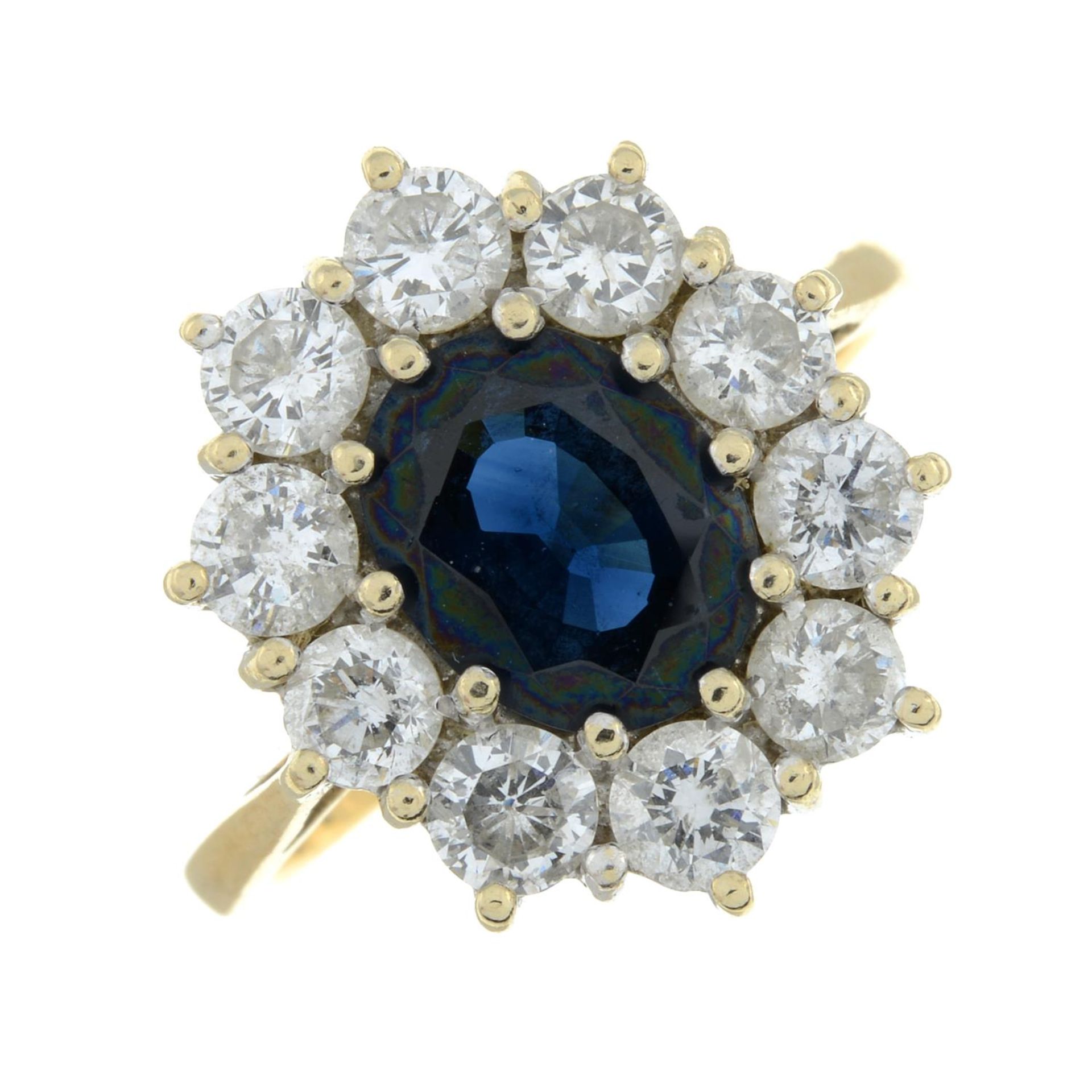 An 18ct gold sapphire and brilliant-cut diamond cluster ring.Sapphire calculated weight 1.82cts,