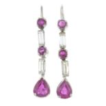 A pair of ruby and baguette-cut diamond drop earrings.