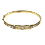A late 19th century gold old-cut diamond and split pearl bangle,