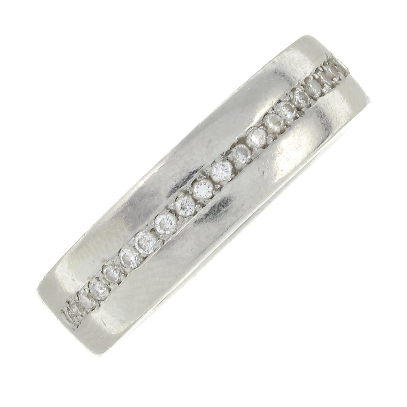 A palladium brilliant-cut diamond band ring.Estimated total diamond weight 0.25ct.Hallmarks for