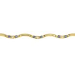 A sapphire and brilliant-cut diamond undulating bracelet.Estimated total diamond weight