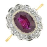 An 18ct gold ruby and brilliant-cut diamond cluster ring.Ruby calculated weight 1.26cts,