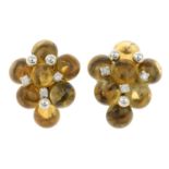 A pair of circular citrine cabochon and brilliant-cut diamond cluster earrings.Estimated dimensions