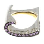 An 18ct gold pink sapphire and brilliant-cut diamond scroll ring.Estimated total diamond weight