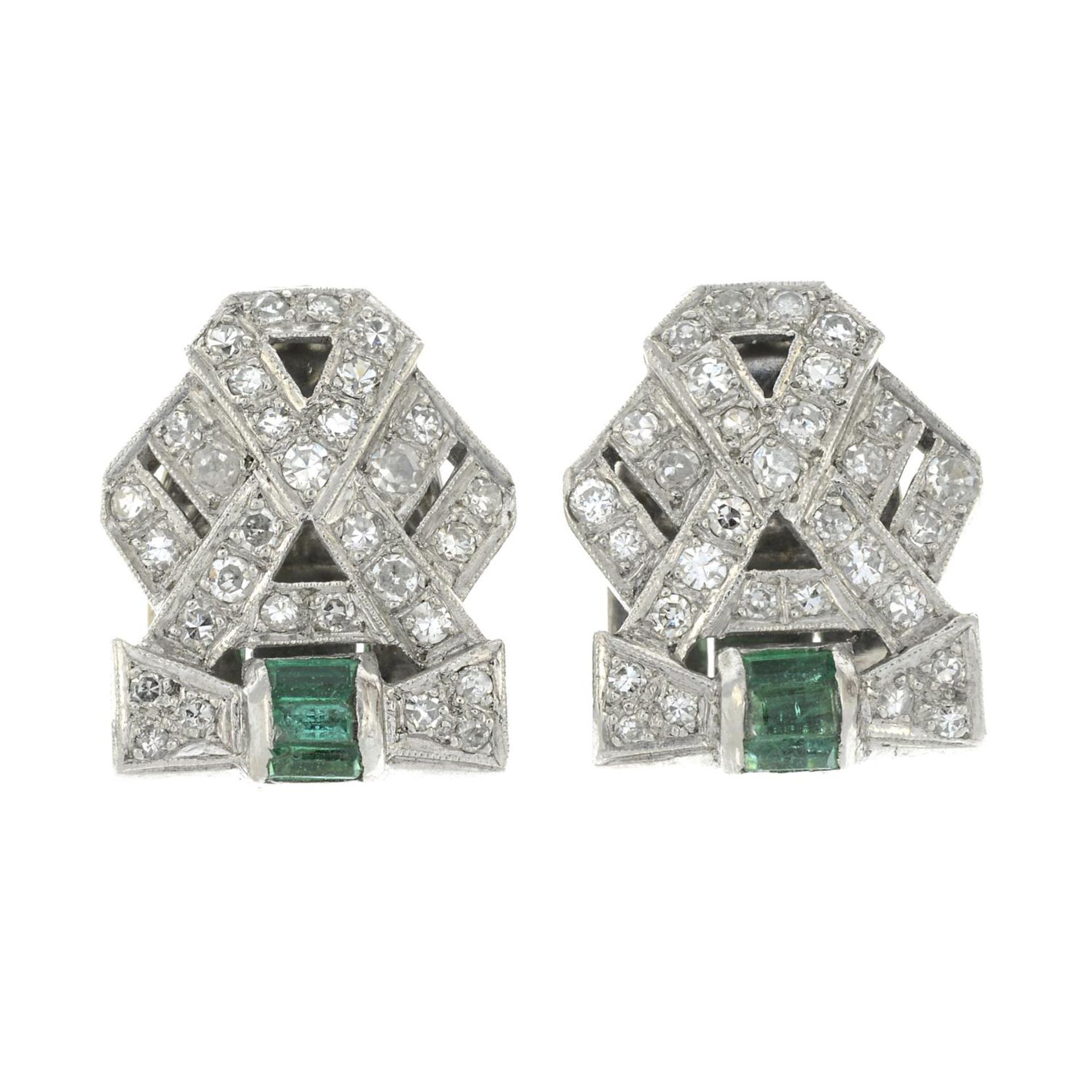 A pair of Art Deco Platinum single-cut diamond and emerald clips.Estimated total diamond weight