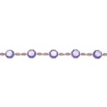 An 18ct gold amethyst and pink sapphire bracelet.Total amethyst weight 13.68cts,