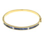 A sapphire and diamond hinged bangle.Stamped 750.Inner diameter 5.7cms.