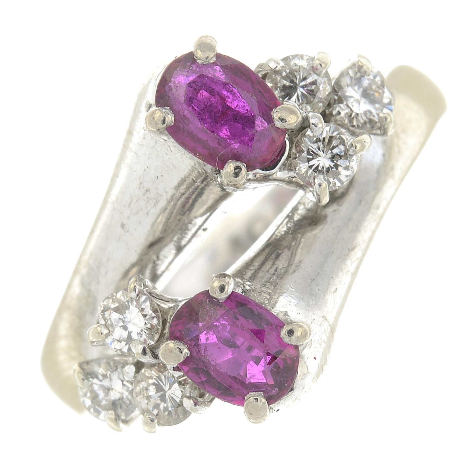 A ruby and brilliant-cut diamond crossover ring.Estimated total diamond weight 0.20ct,