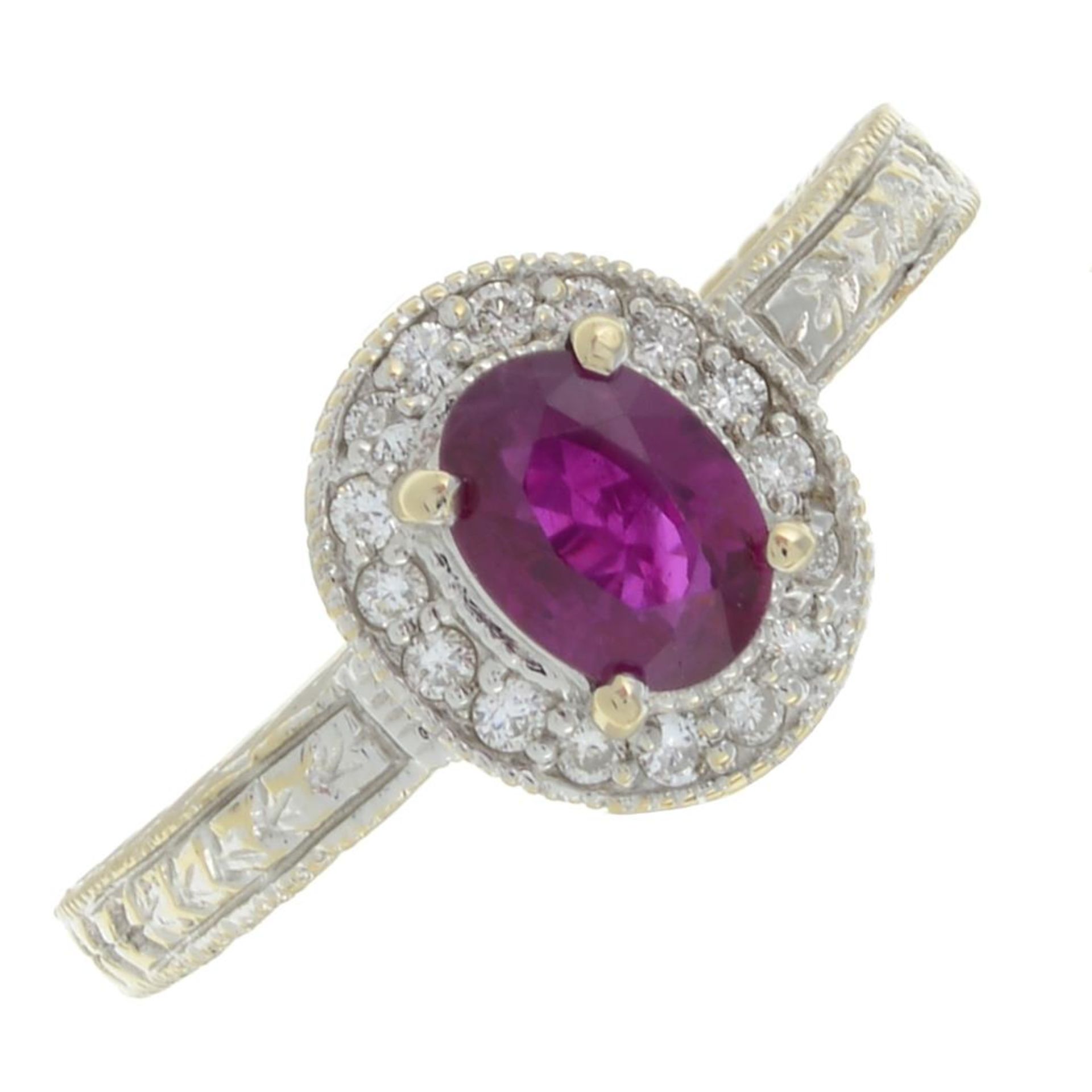 A brilliant-cut diamond and ruby dress ring.Estimated total diamond weight 0.15ct.Stamped 18k.Ring
