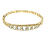 A 9ct gold aquamarine and brilliant-cut diamond hinged bangle.Largest aquamarine calculated weight