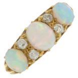 An opal cabochon three-stone ring,