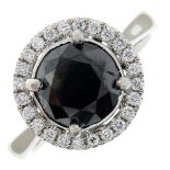 A brilliant-cut 'black' diamond and pave-set diamond cluster ring.Principal diamond estimated