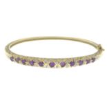 A 9ct gold amethyst and diamond hinged bangle.Two diamonds deficient.Hallmarks for 9ct gold,