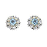 A pair of brilliant-cut diamond and aquamarine cluster earrings.Estimated total diamond weight