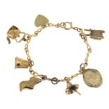 A child's charm bracelet, suspending six 9ct gold charms.Charms with hallmarks for 9ct gold.