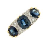 An 18ct gold sapphire three-stone ring, with diamond spacers.