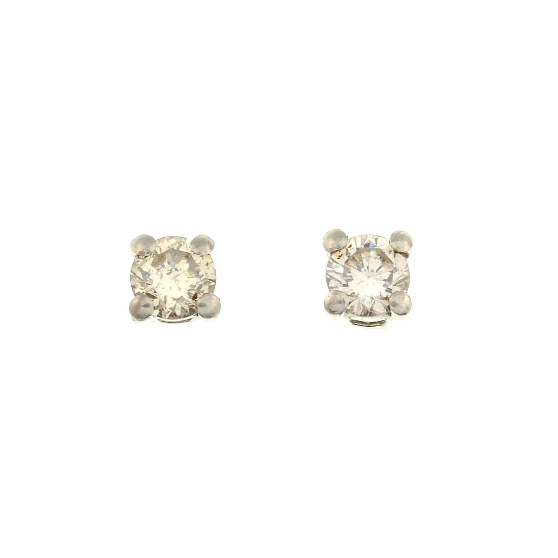 A pair of 18ct gold diamond stud earrings.Estimated total diamond weight 0.40ct,