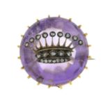 An amethyst and diamond crown brooch.