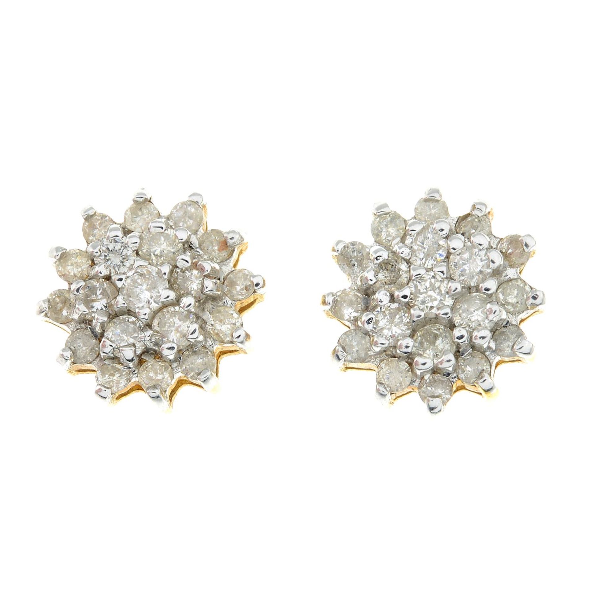 A pair of diamond cluster earrings.Estimated total diamond weight 1ct.