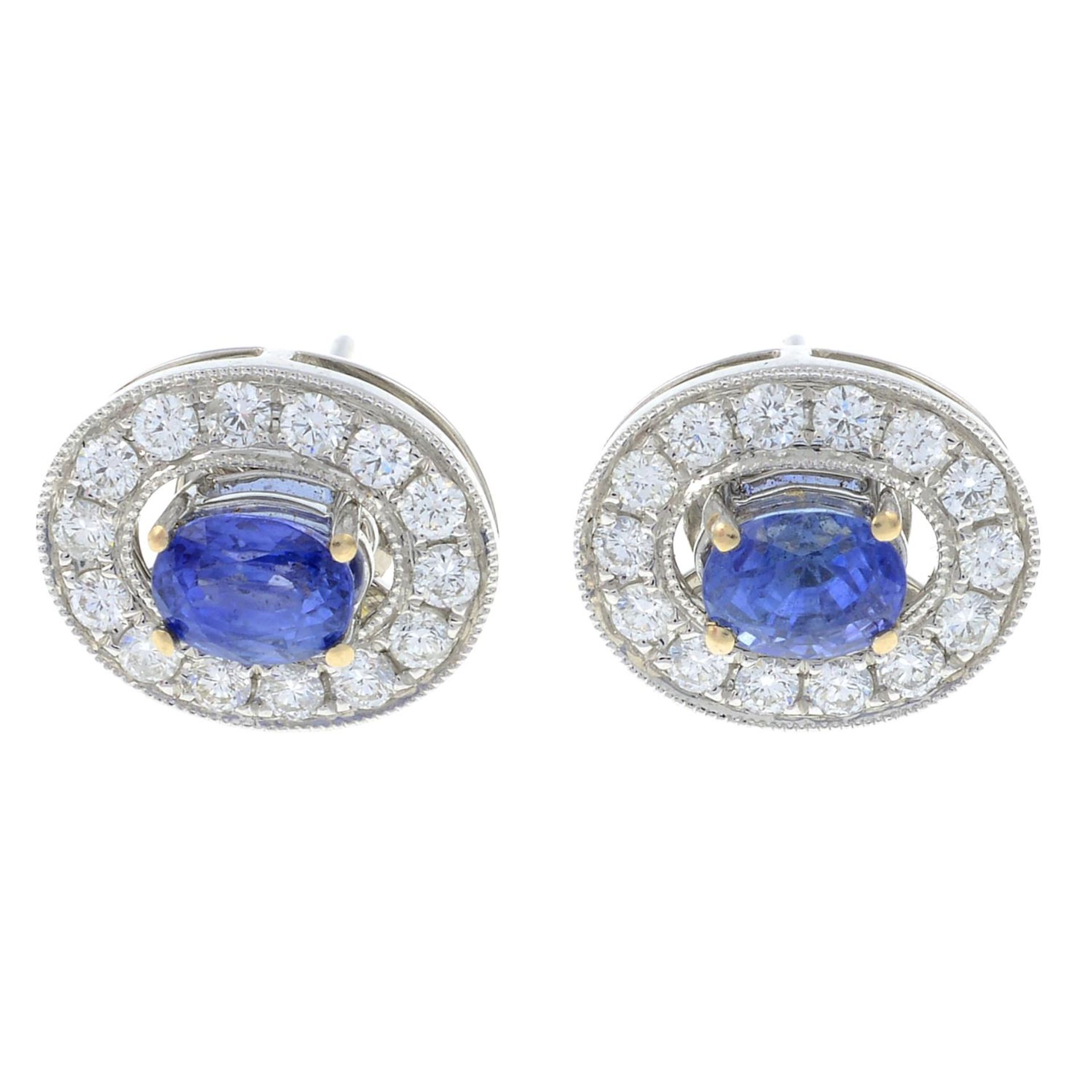 A pair of sapphire stud earrings with removable diamond hoop surround.Total diamond weight 0.49ct,