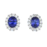 A pair of diamond and sapphire cluster earrings.Total sapphire weight 0.84ct,