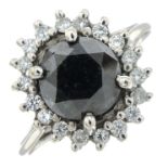 A black gem and diamond cluster ring.Estimated total diamond weight 0.25ct.Ring size K.