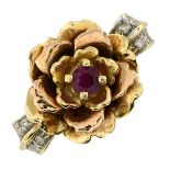 A 14ct gold ruby and diamond flower ring.Import marks for Birmingham.Ring size Q.