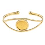 A half sovereign cuff bangle.Half sovereign dated 1908.Inner diameter 6.6cms.