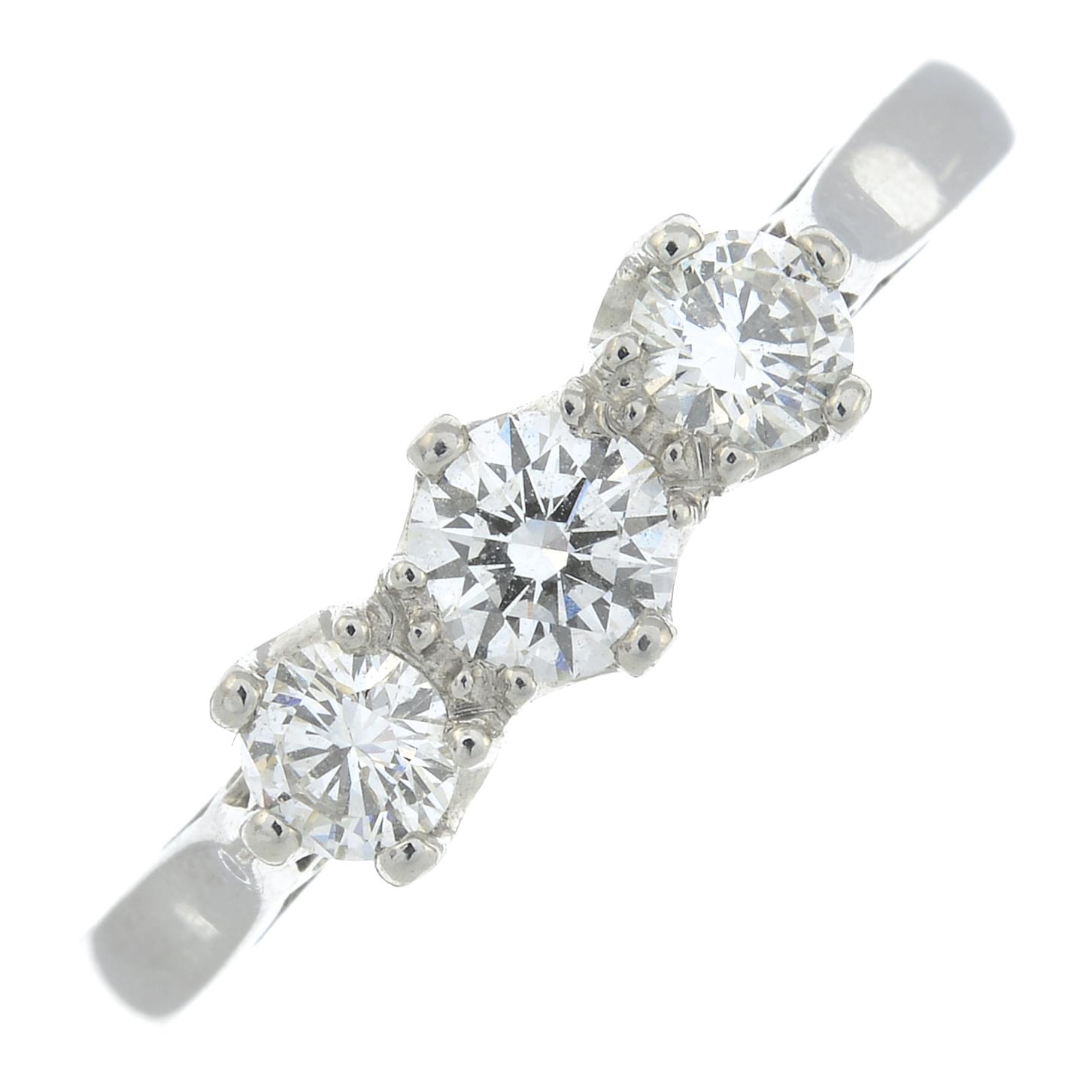 A platinum diamond three-stone ring.Total diamond weight 0.65ct,
