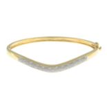 A 9ct gold single-cut diamond hinged bangle.Total diamond weight 0.10ct,