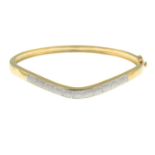 A 9ct gold single-cut diamond hinged bangle.Total diamond weight 0.10ct,