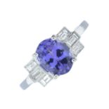A tanzanite and baguette-cut diamond dress ring.Estimated total diamond weight 0.30ct.Stamped