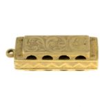 A 9ct gold harmonica pendant.Hallmarks for 9ct gold.