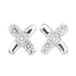 A pair of diamond stud earrings.Total diamond weight 0.10ct, stamped to mount.