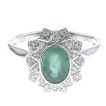An emerald and diamond cluster ring.Emerald weight 0.85ct,