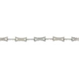 A textured fancy-link bracelet, with polished bar spacers.Stamped 750.