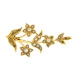 An early 20th century gold seed and split pearl floral brooch.AF.Length 4.5cms.