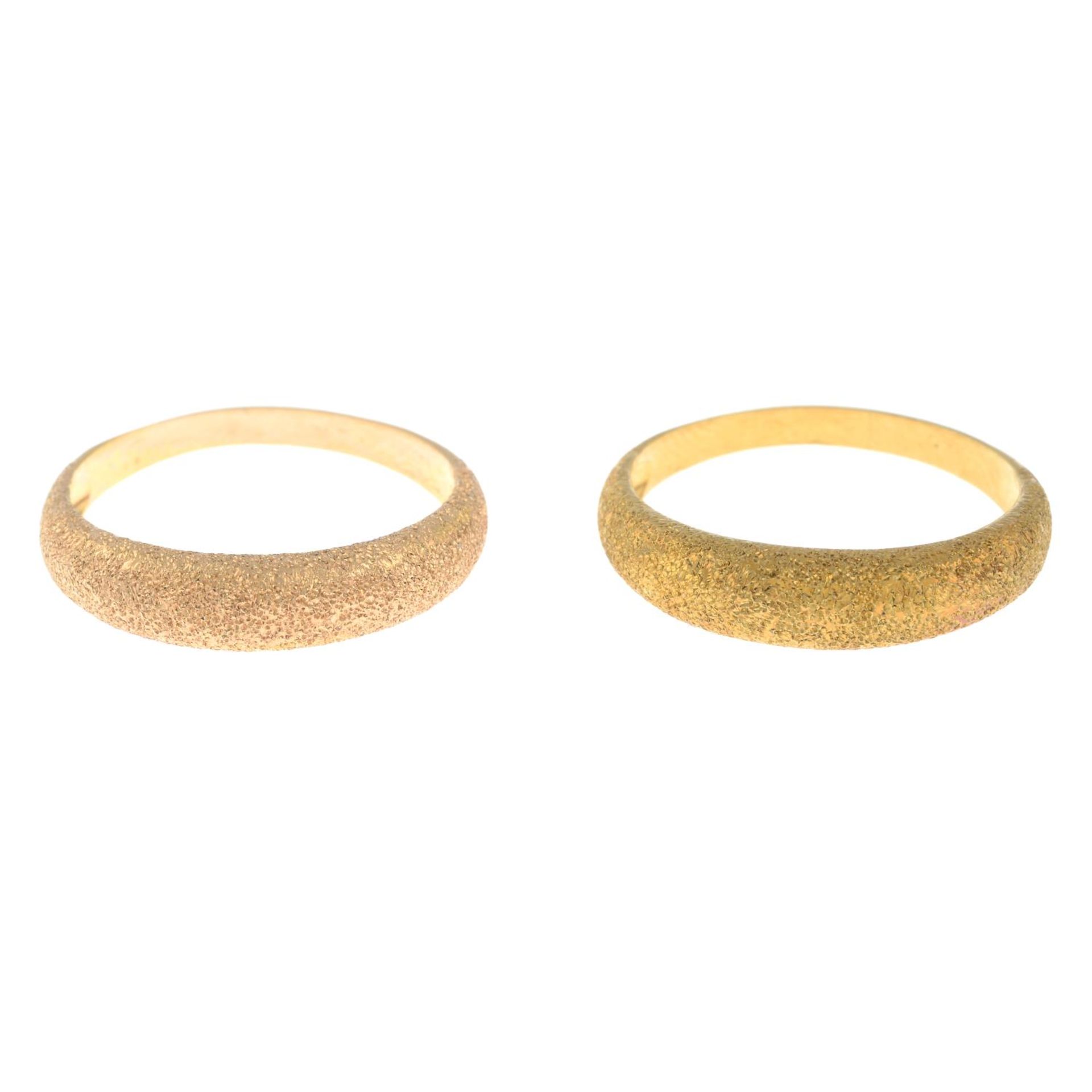 Two rings, each with textured front.Stamped 750.