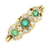 An 18ct gold emerald and diamond dress ring.Four diamonds deficient.