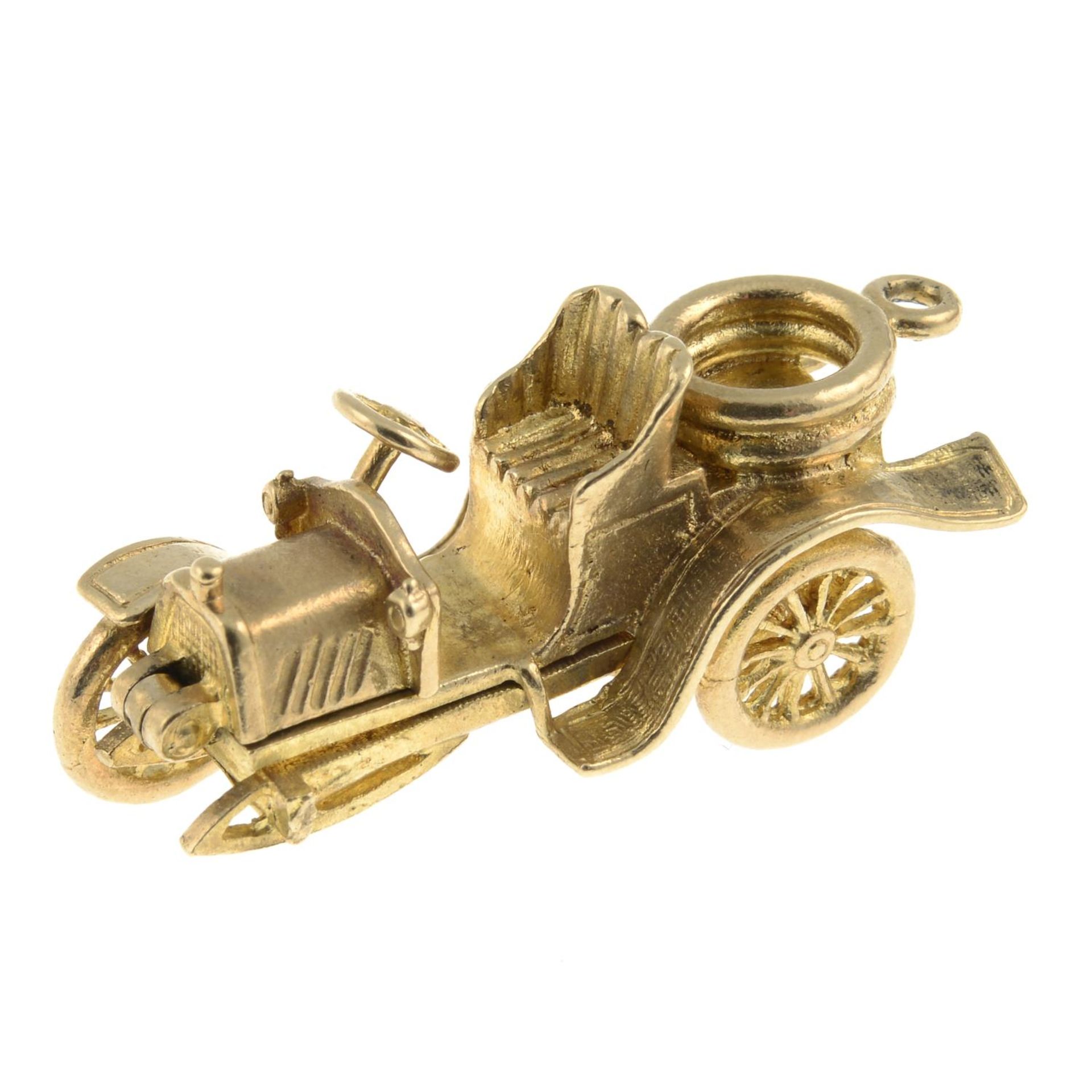 A 9ct gold charm, designed as a vintage car, open to reveal engines.Hallmarks for 9ct gold. - Image 2 of 3