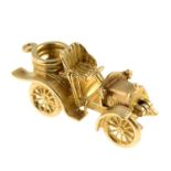 A 9ct gold charm, designed as a vintage car, open to reveal engines.Hallmarks for 9ct gold.