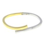 A 9ct bi-colour gold hinged bangle.Hallmarks for London.Inner diameter 6cms.