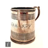 A George II hallmarked christening tankard of plain form with reeded band decorations and acanthus