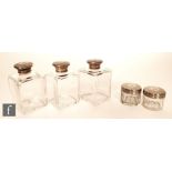 Three Victorian hallmarked silver and clear glass cologne bottles, canted square glass bodies