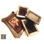 Four early 20th Century hallmarked silver easel photograph frames of various sizes and shapes,