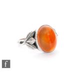 Unknown - An Arts and Crafts silver ring with central chalcedony cabochon within a border of